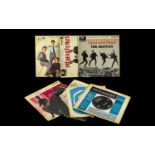 A Collection of Vinyl Single Records including The Beatles, Twist and Shout,
