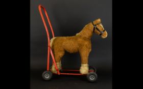 Tri-Ang Push Along Toy In The Form Of A Shire Horse Red metal frame with rubber wheels and