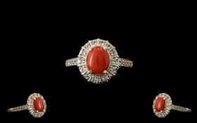 Natural Coral and White Topaz Halo Ring, an oval cut cabochon of natural coral from the