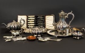 A Mixed Collection Of Plated Metal Ware To include a four piece tea service, embossed trays,