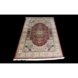 A Very Large Woven Silk Carpet Keshan rug with red ground and traditional Middle Eastern floral and