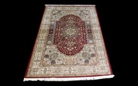 A Very Large Woven Silk Carpet Keshan rug with red ground and traditional Middle Eastern floral and