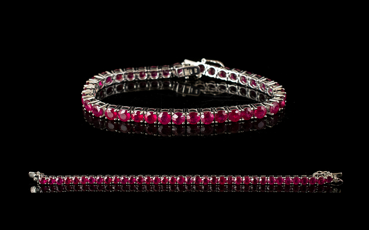 Ruby Tennis Bracelet, 50 round cut rubies of rich, glowing red, each measuring .5ct, an overall