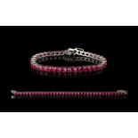 Ruby Tennis Bracelet, 50 round cut rubies of rich, glowing red, each measuring .5ct, an overall