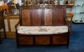 Early 20th Century Carved Oak Monks Bench Panelled back with carved top and hinged seat with