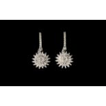 Diamond 'Sunflower' Drop Earrings, each earring having a 'sunflower' comprising a central cluster of