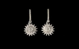 Diamond 'Sunflower' Drop Earrings, each earring having a 'sunflower' comprising a central cluster of