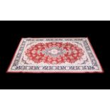 A Modern Persian Style Carpet Poly blend woven rug on red ground with traditional floral and