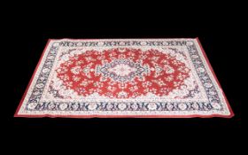 A Modern Persian Style Carpet Poly blend woven rug on red ground with traditional floral and