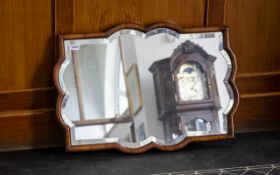 Early 20th Century Over Mantle Mirror Of shaped form with mahogany frame, 20 x 27 inches.