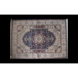 A Large Woven Silk Carpet Keshan rug with blue ground and traditional Middle Eastern floral and