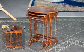 Antique Mahogany Nest of Tables of elegant oval form, raised on turned legs,