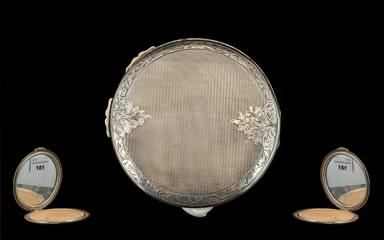 A Mid 20th Century Silver Compact Large and impressive circular compact with machine etched floral