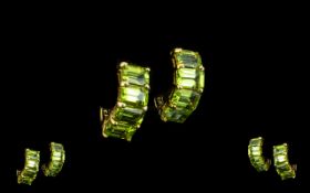 Peridot Pair of Huggie- Hoop Earrings, each earring having four octagon cut peridots,