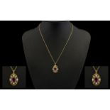 A 9ct Gold Amethyst And Seed Pearl Pendant Necklace Quatrefoil form yellow gold filigree pendant,