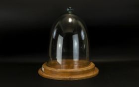 A Large Glass Dome Stand in the Victorian Style, of typical form with oak effect circular base,