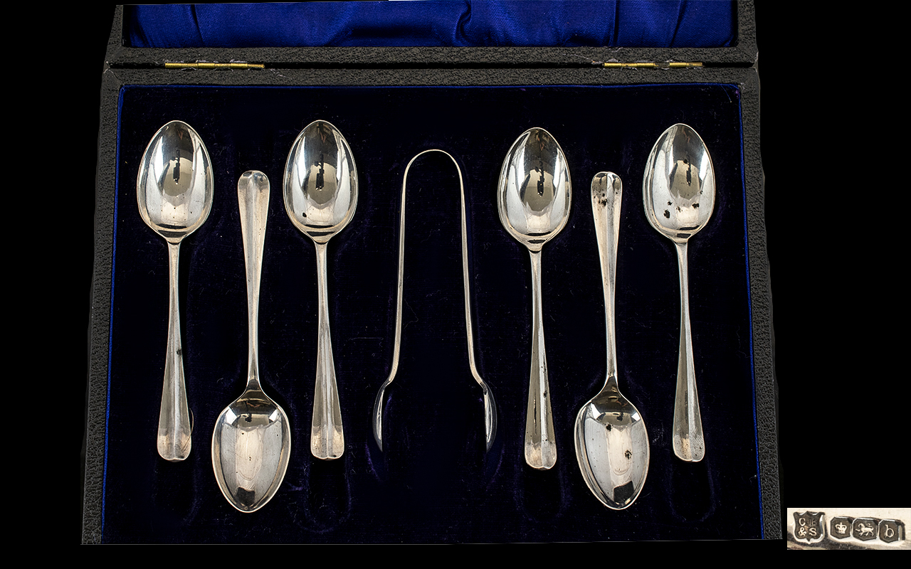 A Boxed Set of 6 Silver Hall Marked spoons with matching tongs. Sheffield 1919. Makers C B and S.