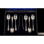 A Boxed Set of 6 Silver Hall Marked spoons with matching tongs. Sheffield 1919. Makers C B and S.