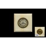 An Early 20th Century Travel Clock Square form clock set in cream cellulose,