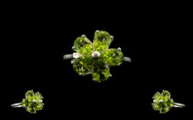 Peridot Flower Ring, five pear cut peridots, totalling 3.