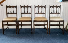 A Set Of Four Jacobean Style Dining Chairs carved and spindle back with drop-in seat,