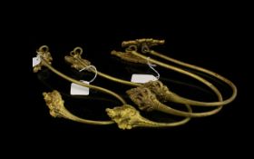 Two Pairs Of Antique Gilt Curtain Tie Backs Crook form hold backs with gilt ormolu finish,