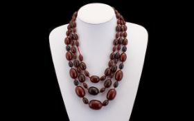 Fine Quality 1920s Cherry Amber Triple Strung Graduated Necklace of pleasing form.