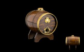 Small Oak Barrel with brass fittings and cork stopper. 8" width, 7" height including stand.