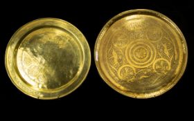 A Pair Of Middle Eastern Brass Chargers Circular form with etched patterning of traditional design,