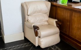 Cream Leather Electric Recliner Chair with wooden arms and raised on wheels.