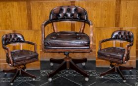 A Mahogany And Leather Captains Chair Of traditional form and generous proportion,