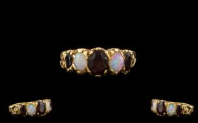 A 9ct Gold Opal And Garnet Set Ring Fully hallmarked for 9ct gold,