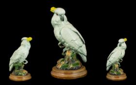 Vintage Cockatoo Figure raised on a wooden base,