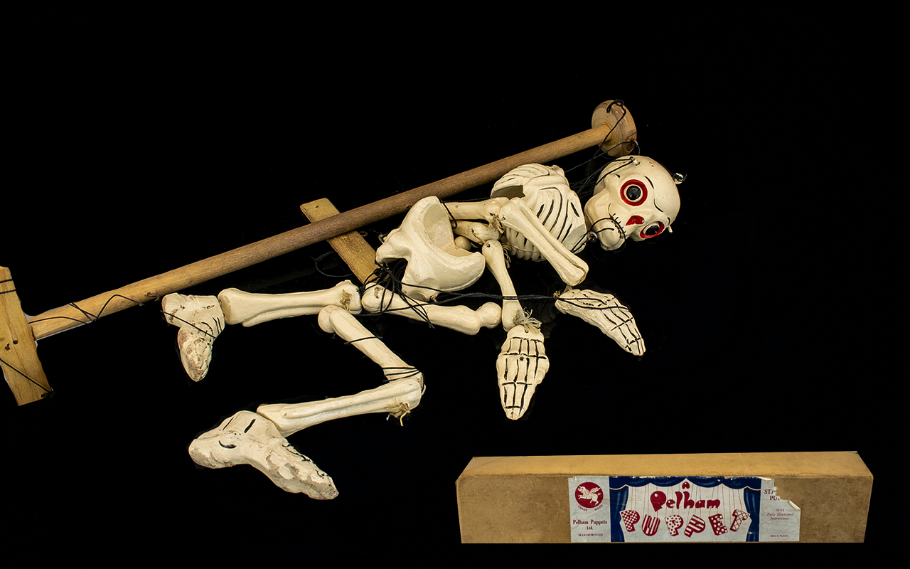 A Pelham Puppet In The Form Of A Skeleton Detaching Limbs And Lifting Head. Needs To Be Untangled.