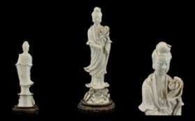 19thC Chinese Blanc-de-chine Guanyin Figure, raised on a circular hardwood stand.