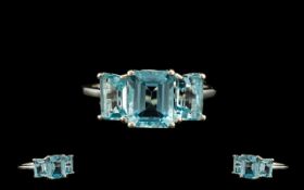 Ice Blue Topaz Trilogy Ring, an octagon cut sparkling ice blue topaz of 2.