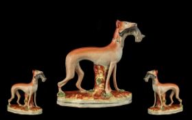 A Staffordshire Flatback Figure In the form of a greyhound with quarry,