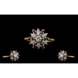 18ct Gold Diamond and Ruby Set Ladies Ring of starburst design. Marked 750-18ct.