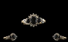 9ct Gold Attractive Diamond And Sapphire Set Dress Ring The central sapphire surrounded by 10