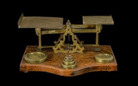 A 1920's Oak And Lacquered Brass Pan Scales marked 'Warranted accurate' mounted on shaped oak base,