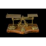 A 1920's Oak And Lacquered Brass Pan Scales marked 'Warranted accurate' mounted on shaped oak base,