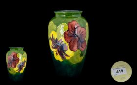 Moorcroft Tubelined Ovoid Shaped Vase ' Hibiscus ' Design on Enamel Green Ground. Height 8.