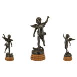 A Cast Metal Figure In The Form Of A Classical Winged Putti Bronzed metal figure raised on stepped