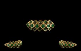 A 9ct Gold And Emerald Set Dress Ring Three interlocking rows set with faceted emerald,