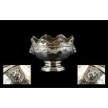 A Silver Footed Bowl Raised on stepped circular base with heraldic style meandering edge and lion