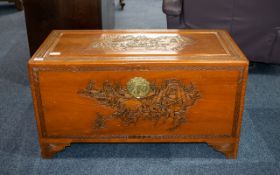 Camphor Chest, Oriental carved lid and sides depicting fighting warrior scenes.