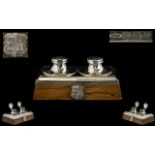 A Silver Arts And Crafts Dual Well Inkstand Of rectangular form, raised on golden oak base,