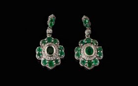 Emerald and Zircon Drop Earrings, each pendant drop having an oval cut emerald, bezel set,