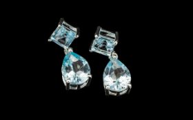 Ice Blue Topaz Drop Earrings, each comprising a pear cut topaz of 1.