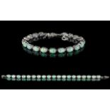 A Contemporary Silver And Opal Set Tennis Bracelet - Comprising 19 Oval Cabochon Opals.
